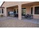 Covered back patio featuring a hot tub and cozy outdoor seating area at 17111 S 180Th Ln, Goodyear, AZ 85338
