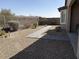 Backyard featuring a stone walkway, desert landscaping, and wrought iron fence at 17111 S 180Th Ln, Goodyear, AZ 85338