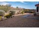 Landscaped backyard with desert plants, stone walkway and secure metal fencing at 17111 S 180Th Ln, Goodyear, AZ 85338