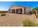 Rear exterior showcasing a covered patio, low-maintenance landscaping, and outdoor seating at 17111 S 180Th Ln, Goodyear, AZ 85338