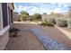 Backyard featuring desert landscaping, a stone walkway, and a secure fence at 17111 S 180Th Ln, Goodyear, AZ 85338