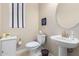 Cozy powder room with a pedestal sink, decorative mirror, and white fixtures at 17111 S 180Th Ln, Goodyear, AZ 85338