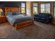 Comfortable bedroom features wood furnishings, blue accents, and ample natural light at 17111 S 180Th Ln, Goodyear, AZ 85338