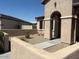 View of home's facade highlighting an arched entrance and charming desert-style landscaping at 17111 S 180Th Ln, Goodyear, AZ 85338