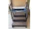 Hot tub with steps and handrails for easy access, covered by a protective lid at 17111 S 180Th Ln, Goodyear, AZ 85338