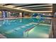 Bright indoor pool area featuring clear water, a mural, and ample space for relaxation at 17111 S 180Th Ln, Goodyear, AZ 85338