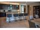 Well-appointed kitchen with a large island, dark cabinetry, granite counters, and stylish lighting at 17111 S 180Th Ln, Goodyear, AZ 85338