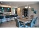 Beautiful kitchen featuring dark cabinets, granite counters, pendant lights, and a dining area at 17111 S 180Th Ln, Goodyear, AZ 85338