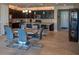 Open-concept kitchen with dark wood cabinetry, granite countertops, and a stylish dining area at 17111 S 180Th Ln, Goodyear, AZ 85338