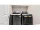 Laundry area featuring front-load washer and dryer, with storage shelf and neutral wall color at 17111 S 180Th Ln, Goodyear, AZ 85338