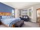 Inviting main bedroom with a blue accent wall, sitting area, and comfortable furnishings at 17111 S 180Th Ln, Goodyear, AZ 85338