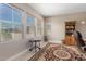 Bright office space featuring multiple windows, a decorative rug, and a built-in bookcase at 17111 S 180Th Ln, Goodyear, AZ 85338