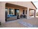 Outdoor patio with a hot tub, comfortable seating, and covered area at 17111 S 180Th Ln, Goodyear, AZ 85338