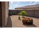 Side yard with low-maintenance desert landscaping and fenced perimeter at 17111 S 180Th Ln, Goodyear, AZ 85338