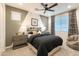 Stylish bedroom featuring neutral tones, a comfortable bed, and patterned curtains, offering a relaxing retreat at 17245 W Corrine Dr, Surprise, AZ 85388