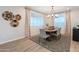 Well-lit dining room with a modern chandelier, stylish rug, decorative wall baskets, and comfortable seating at 17245 W Corrine Dr, Surprise, AZ 85388