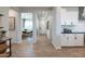 Inviting entryway with bright lighting, wood-look floors, and an open view of the kitchen and office space at 17245 W Corrine Dr, Surprise, AZ 85388