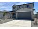 Beautiful two-story home featuring a gray color scheme, well-kept gravel yard, and a spacious two-car garage at 17245 W Corrine Dr, Surprise, AZ 85388