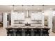 Modern kitchen with white cabinets, stainless steel appliances, a spacious island, and stylish pendant lighting at 17245 W Corrine Dr, Surprise, AZ 85388