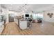 Spacious kitchen with a center island that flows seamlessly into an open-concept living area and stainless appliances at 17245 W Corrine Dr, Surprise, AZ 85388