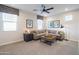 Comfortable loft featuring a sectional sofa, stylish decor, and large windows for natural light at 17245 W Corrine Dr, Surprise, AZ 85388