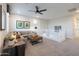 Bright upstairs loft offering a cozy sectional, modern decor, and a view of the staircase at 17245 W Corrine Dr, Surprise, AZ 85388