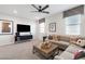 Spacious loft featuring contemporary furnishings, a large TV, and trendy window treatments at 17245 W Corrine Dr, Surprise, AZ 85388