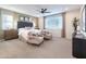 Serene main bedroom boasts a calming color scheme, comfortable seating, and ample natural light at 17245 W Corrine Dr, Surprise, AZ 85388