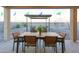 Outdoor patio with a dining table and chairs, perfect for enjoying meals and gatherings in the backyard at 17245 W Corrine Dr, Surprise, AZ 85388
