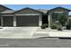 Charming single-story home featuring a two-car garage, desert landscaping, and neutral color palette at 17312 W Dahlia Dr, Surprise, AZ 85388