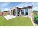 Secluded backyard featuring a covered patio, artificial grass, and mature landscaping at 1847 N Red Clf, Mesa, AZ 85207
