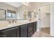 Double vanity bathroom with sleek countertops, modern fixtures, and a bright window at 1847 N Red Clf, Mesa, AZ 85207