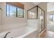Bright bathroom with a large soaking tub, separate shower and a picturesque window view at 1847 N Red Clf, Mesa, AZ 85207