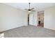 Spacious carpeted bedroom featuring a ceiling fan and ensuite bathroom entrance at 1847 N Red Clf, Mesa, AZ 85207