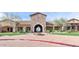 Stunning clubhouse entrance with lush landscaping and stone architecture at 1847 N Red Clf, Mesa, AZ 85207