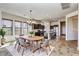 Bright dining room with table and chairs open to kitchen with island and stainless steel appliances at 1847 N Red Clf, Mesa, AZ 85207