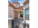 Welcoming covered front entrance with stone accents, iron gate, and a dark wood entry door at 1847 N Red Clf, Mesa, AZ 85207