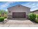 Two car garage with stylish brick paver driveway and decorative stone accents at 1847 N Red Clf, Mesa, AZ 85207