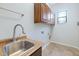 Functional laundry room equipped with a sink, cabinets, and tile flooring at 1847 N Red Clf, Mesa, AZ 85207
