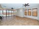 Bright living room boasts ceiling fans, tile floors, and sliding doors to a patio at 1847 N Red Clf, Mesa, AZ 85207