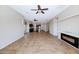 Open living space featuring tile flooring, ceiling fans, and a modern fireplace feature at 1847 N Red Clf, Mesa, AZ 85207