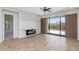 Open living area with tile floors, modern fireplace, and access to the outdoor patio at 1847 N Red Clf, Mesa, AZ 85207