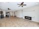 Inviting living room features tile flooring, ceiling fans, modern fireplace, and open concept design at 1847 N Red Clf, Mesa, AZ 85207