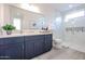 Modern bathroom featuring stylish blue cabinets, quartz countertop and decorative backsplash in glass door shower at 1850 E Creek Canyon Rd, Phoenix, AZ 85086