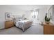 Bright bedroom with plush carpet, decorative bed frame, side tables, and a sun filled window at 1850 E Creek Canyon Rd, Phoenix, AZ 85086