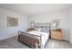 Bedroom with soft carpet, decorative metal bed frame, side tables, and light fixtures at 1850 E Creek Canyon Rd, Phoenix, AZ 85086