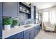 Elegant kitchen with navy blue cabinets, stainless steel appliances, and stylish decor for a modern culinary experience at 1850 E Creek Canyon Rd, Phoenix, AZ 85086