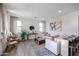 Bright and inviting living room featuring neutral tones, wood floors, and an open layout perfect for modern living at 1850 E Creek Canyon Rd, Phoenix, AZ 85086