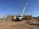 Framing underway at a new home construction site under a clear blue sky at 1904 E Creek Canyon Rd, Phoenix, AZ 85086