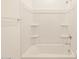 A bright and clean bathroom and shower area with chrome fixtures and shelves at 19422 N Fiano Dr, Maricopa, AZ 85138